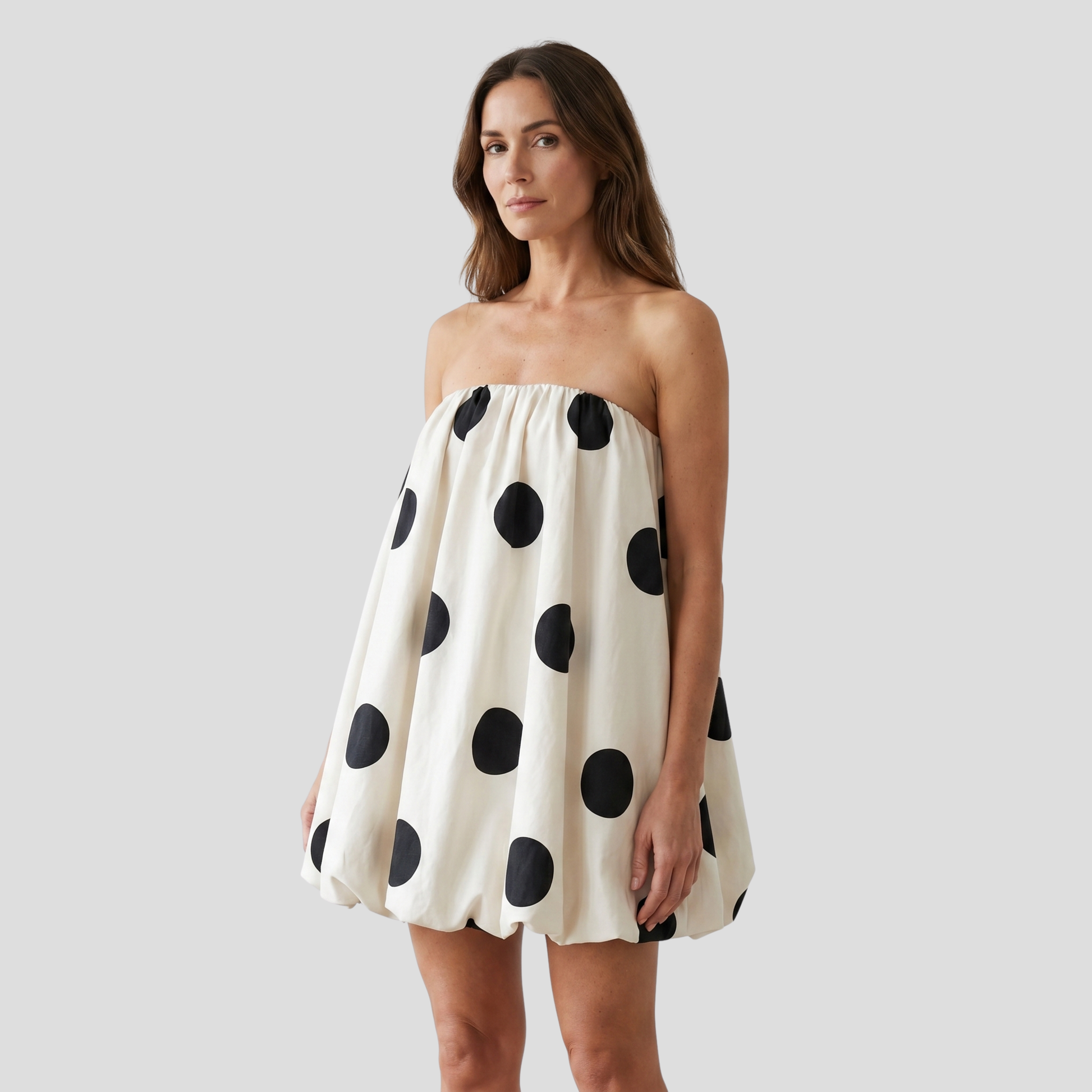 White strapless polka-dot bubble mini dress with gathered volume through the skirt