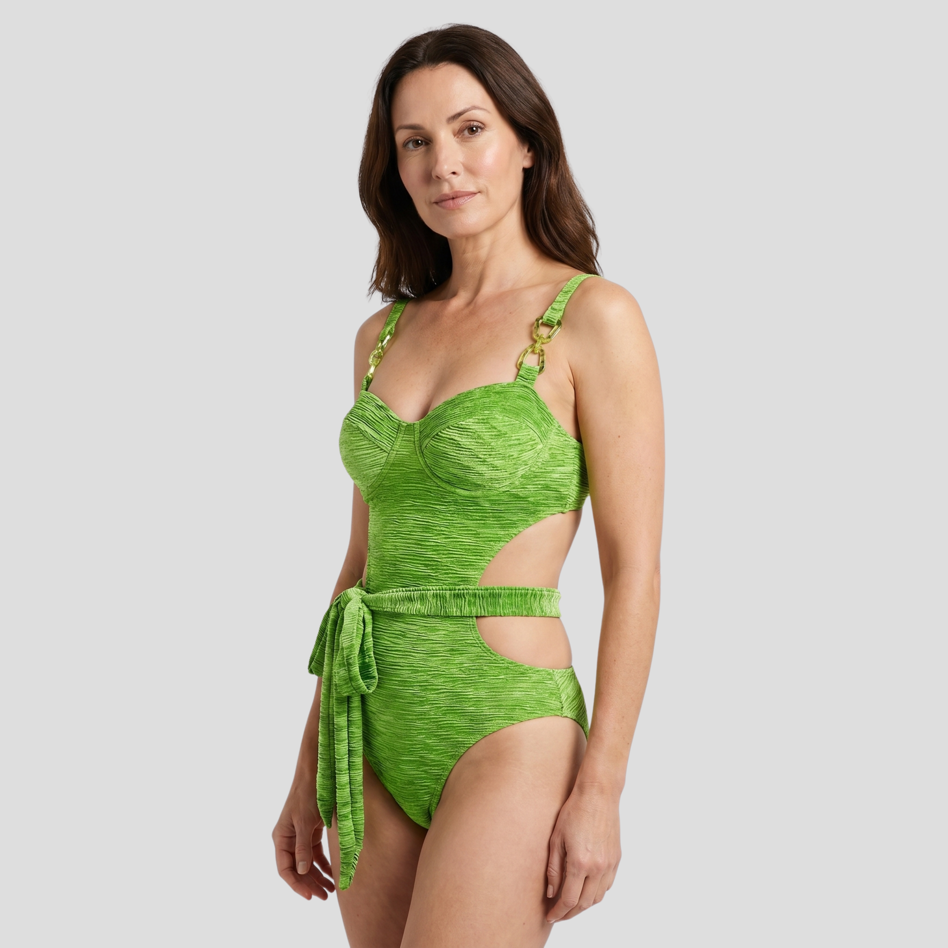 Green one-piece swimsuit with cut-out detail, bustier-style upper and belted waist tie