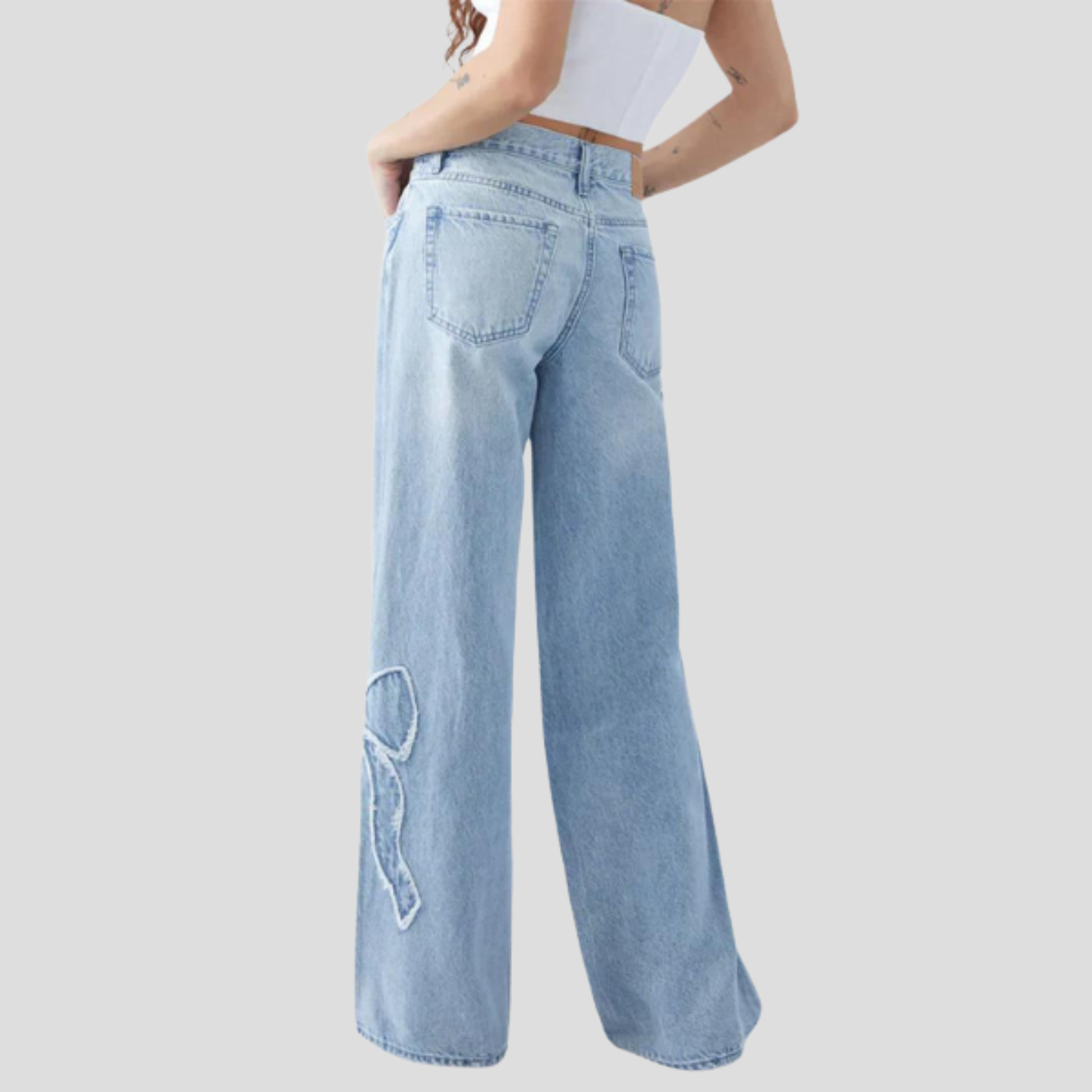 Women's relaxed-fit blue jeans with feminine side bow detail