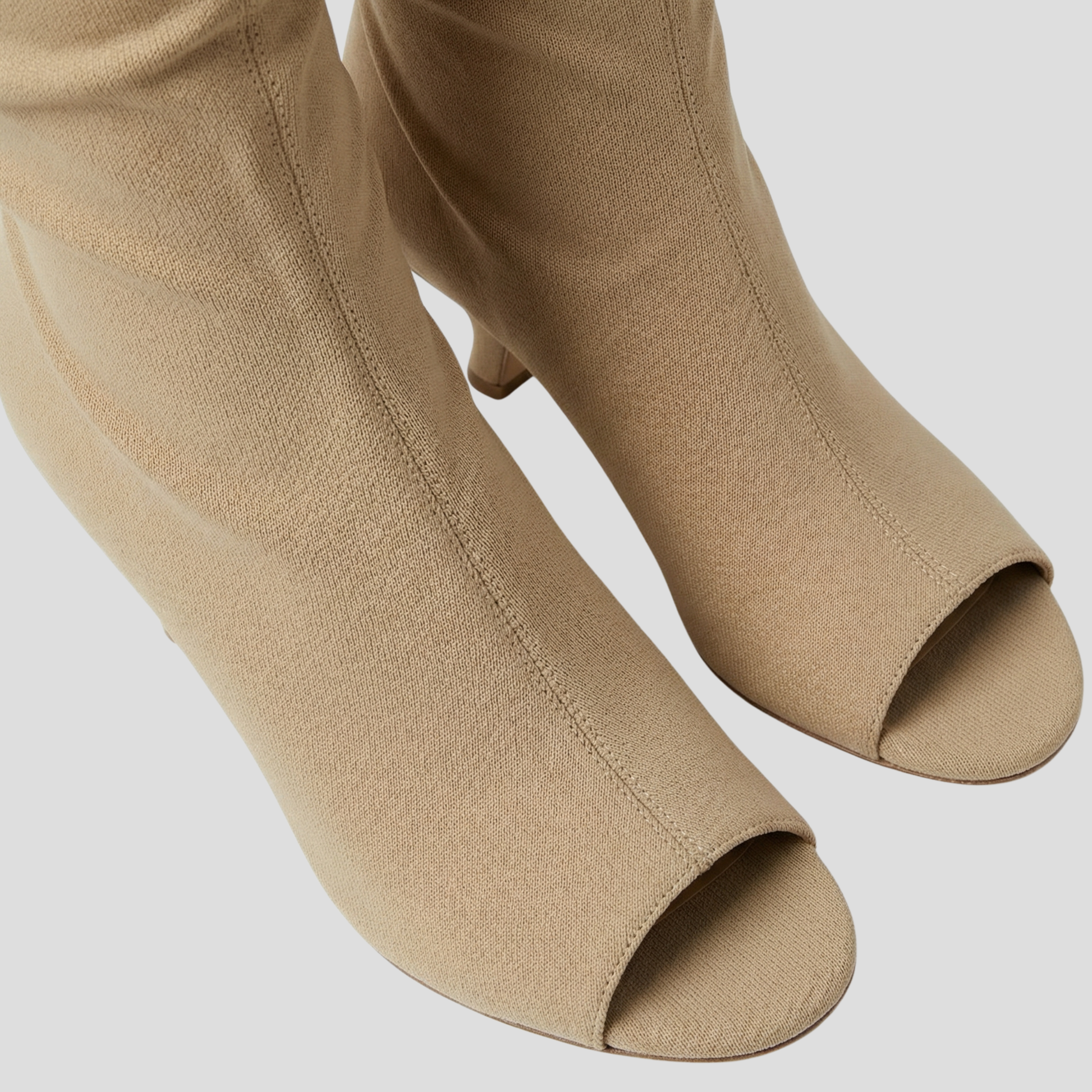 Women's open-toe knee-high boots with a clean vertical structure, shown in a neutral tone
