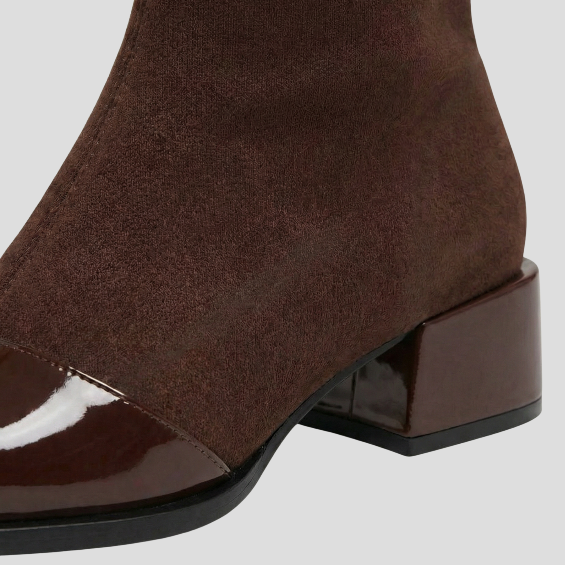 Women's ankle-height boots with contrast detail, shown in black and brown