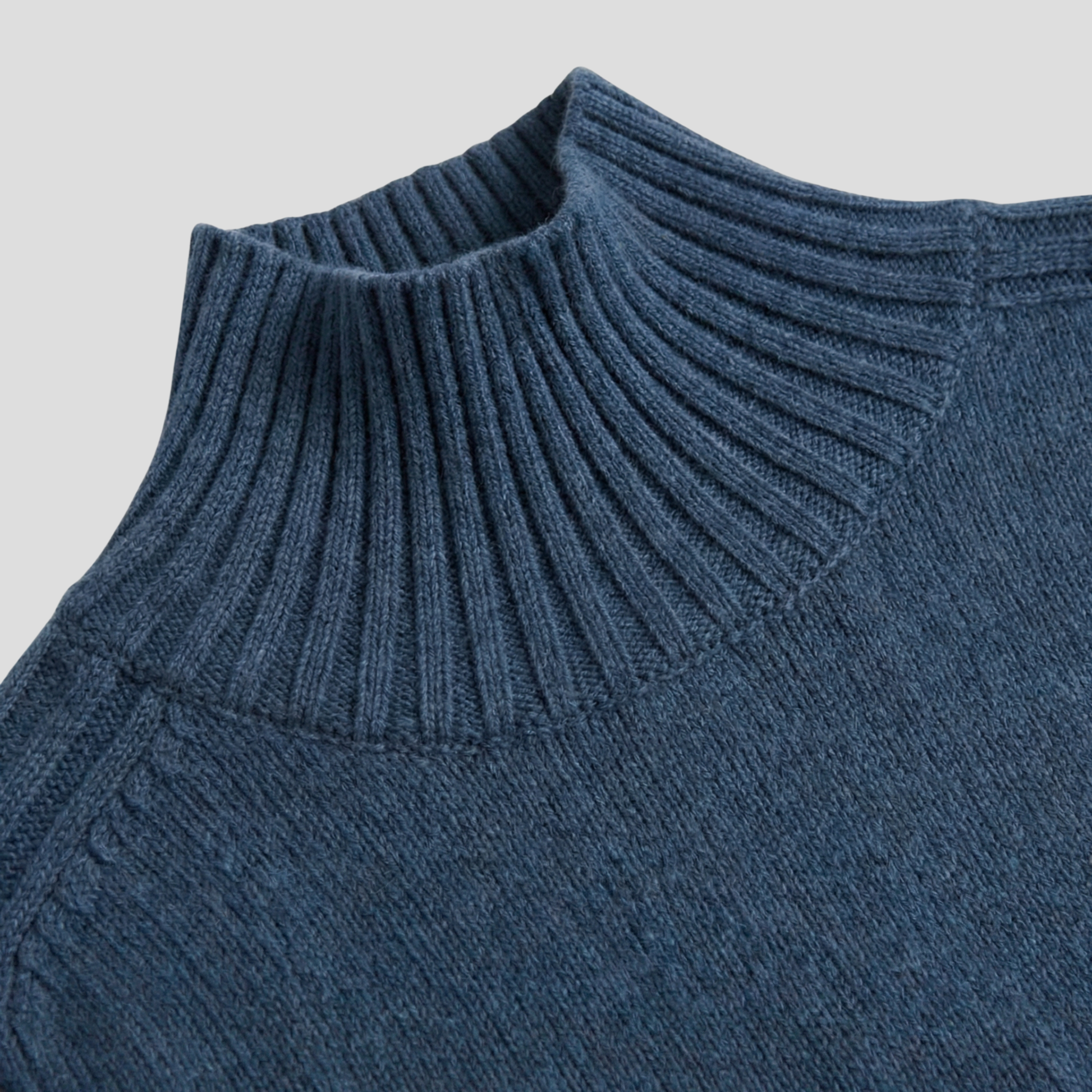 Navy blue ribbed high neck sweater with relaxed silhouette and extended cuffs
