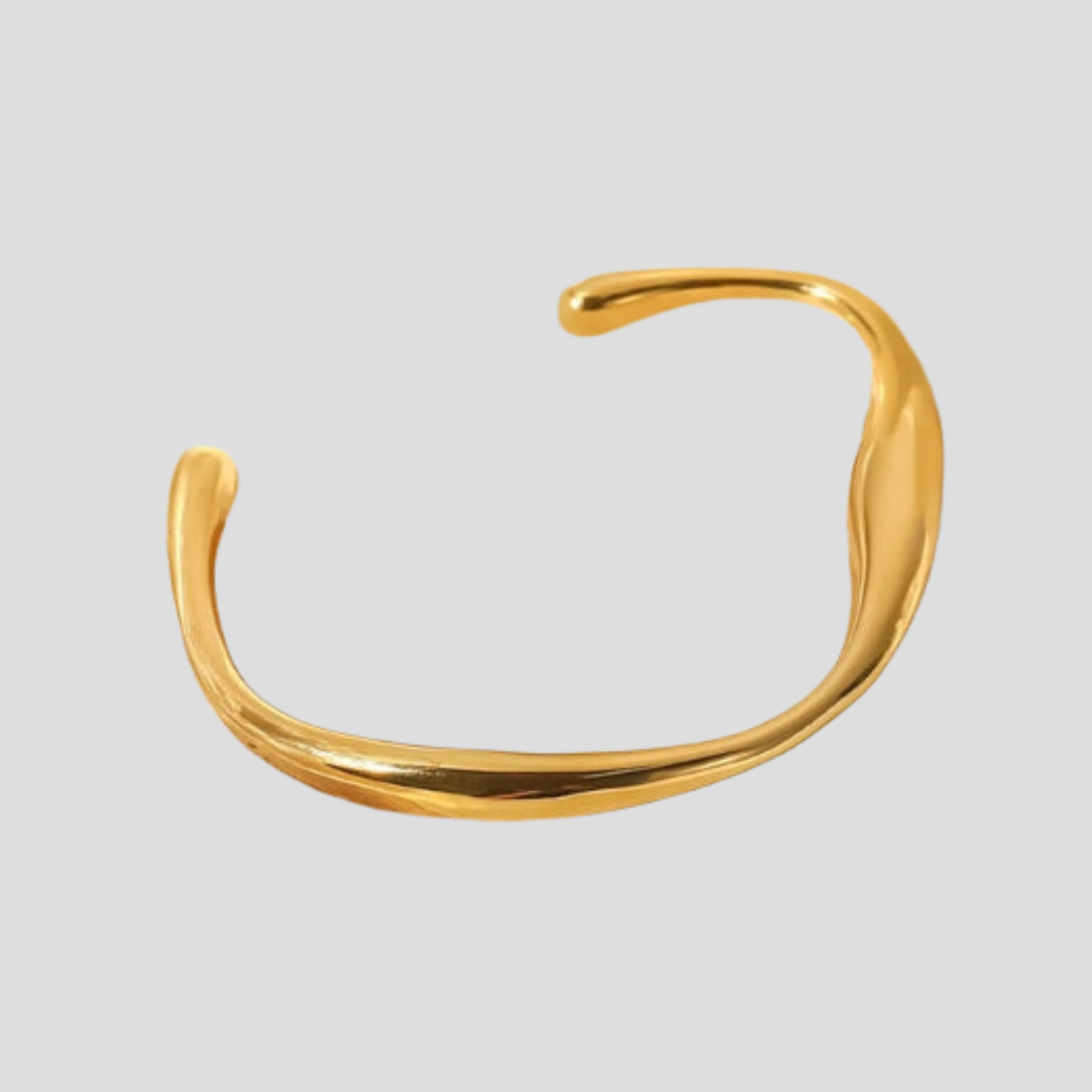 Gold open cuff bracelet with sculpted asymmetrical curve and rounded edges