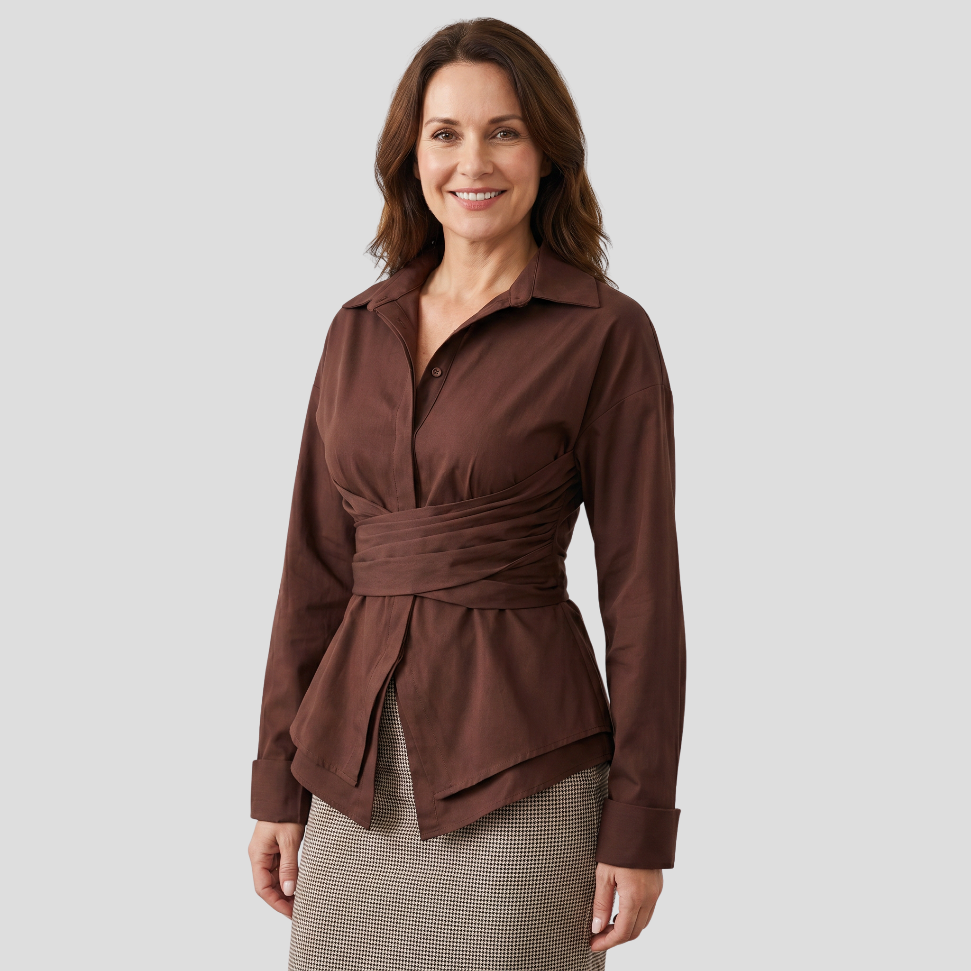 Brown long-sleeve wrap-tie shirt with open collar and layered peplum hem
