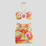 Women's three-piece floral resort set with halter top and wrap-style mini skirt