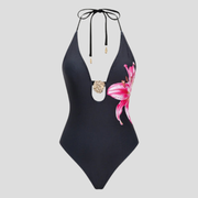 Black deep-V one-piece swimsuit with floral pattern, halter ties and gold-tone accent