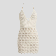White halter neckline mini dress with open-back detail and scalloped hem