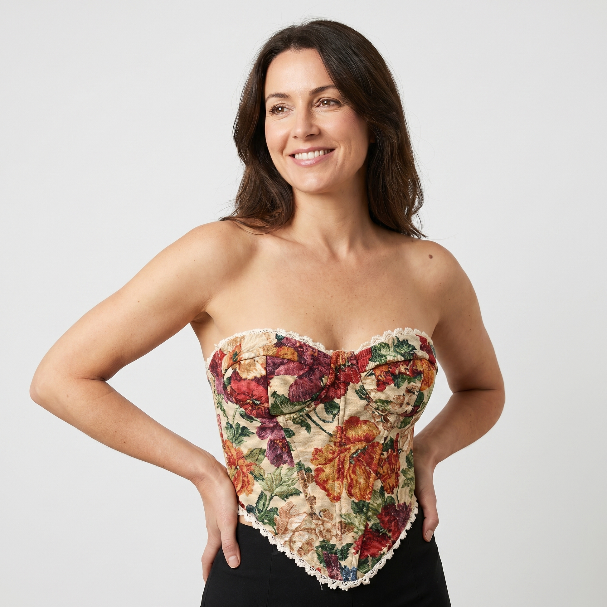 Women's orange floral corset top with scalloped edges and fitted silhouette